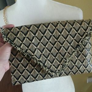 Black and tan woven envelope style purse